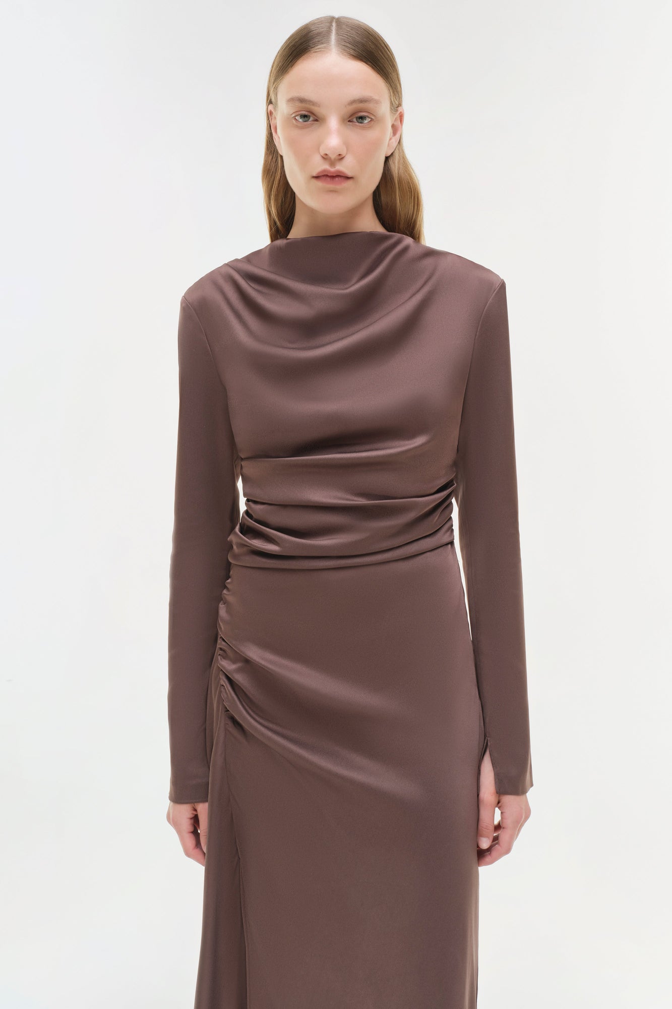 Taupe satin midi dress with long sleeves, cowl neckline, and ruched waist detailing.