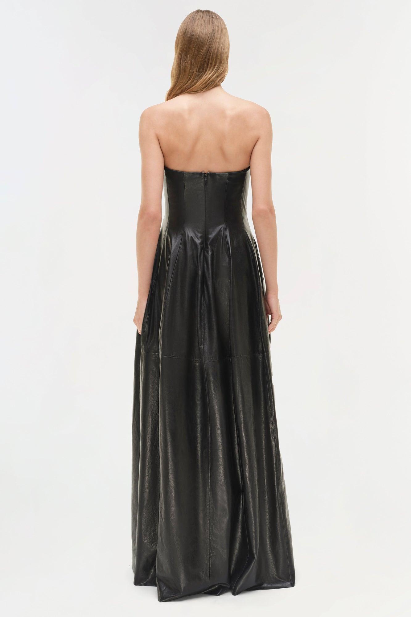 Black leather strapless bustier gown with full-length A-line skirt, shown from back view.