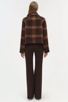 Brown plaid wool cropped jacket with collared neckline, paired with dark brown trousers.
