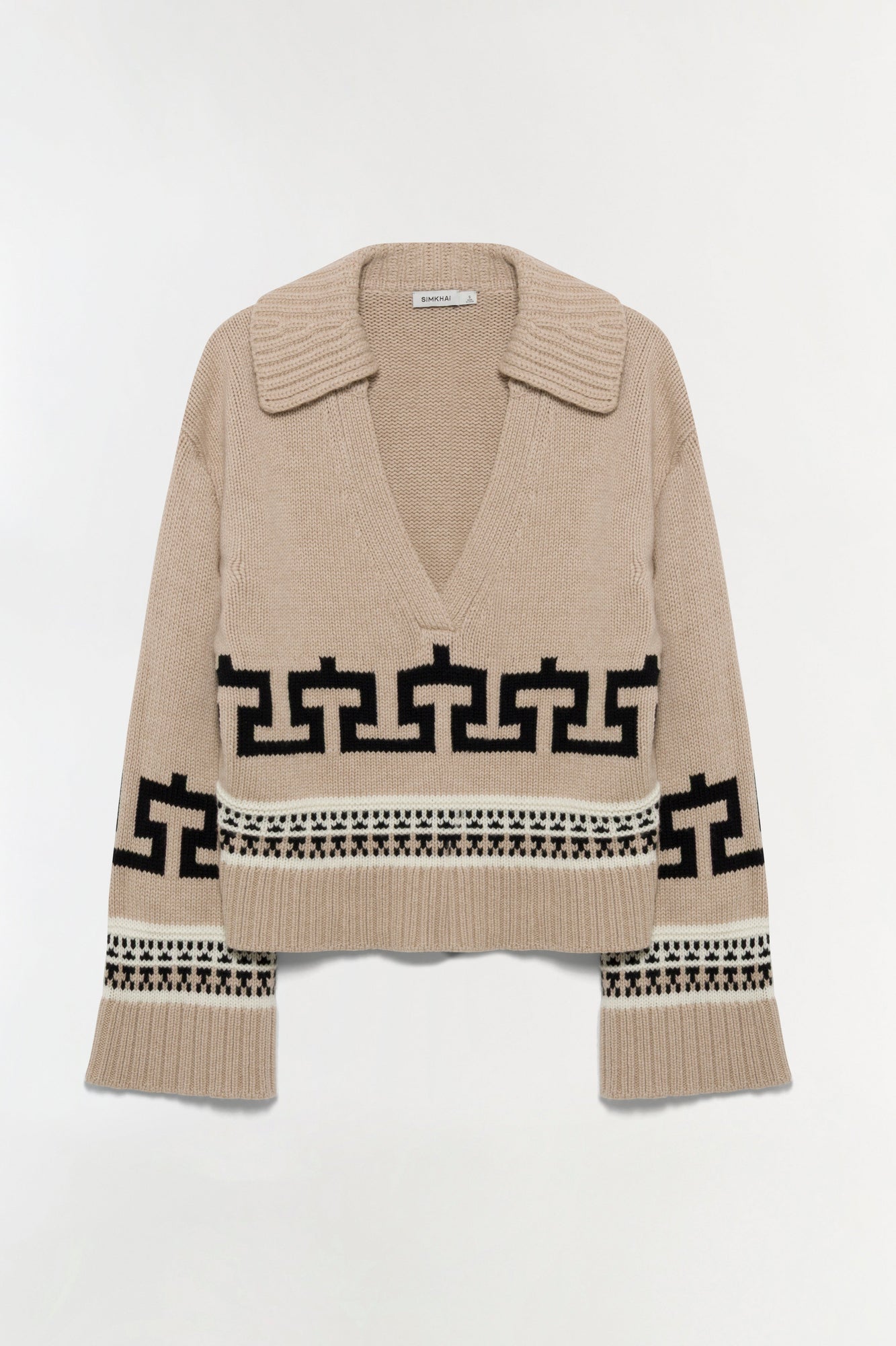 Beige knit sweater with V-neck collar, black geometric patterns across chest and sleeves, ribbed cuffs and hem.