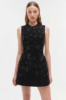 Black sleeveless lace mini dress with silver embellishments and a collared neckline.