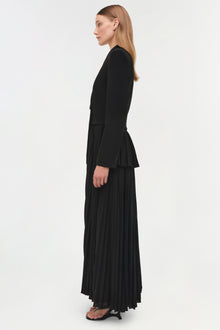 Black blazer midi dress with pleated skirt and button front, shown on model from side profile.