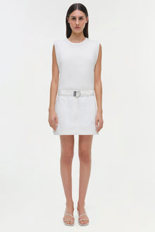 White sleeveless ribbed dress with matching belt and white sandals.