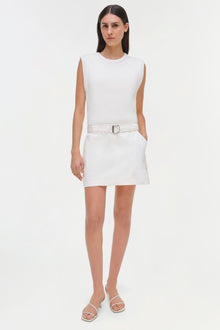 White sleeveless ribbed top with white cargo mini skirt and belt on model.
