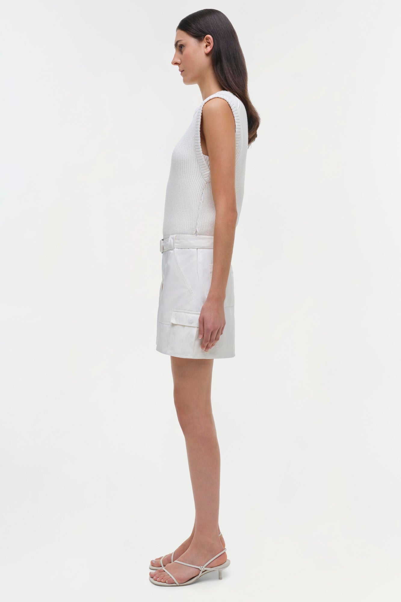 White sleeveless dress with ribbed bodice and cargo-style skirt with belt detail.