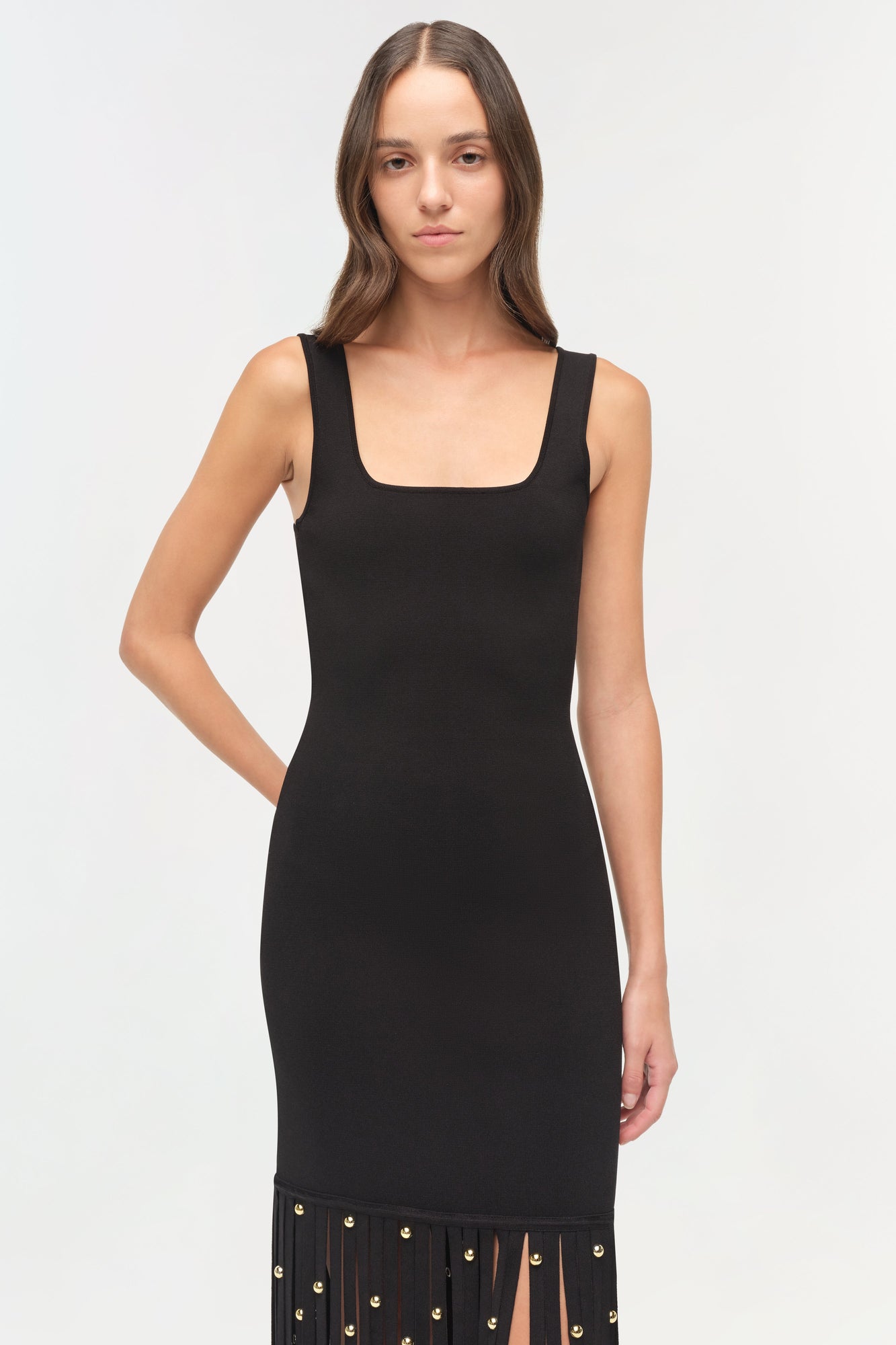 Black sleeveless knit midi dress with square neckline and gold ball embellishments on pleated hem.