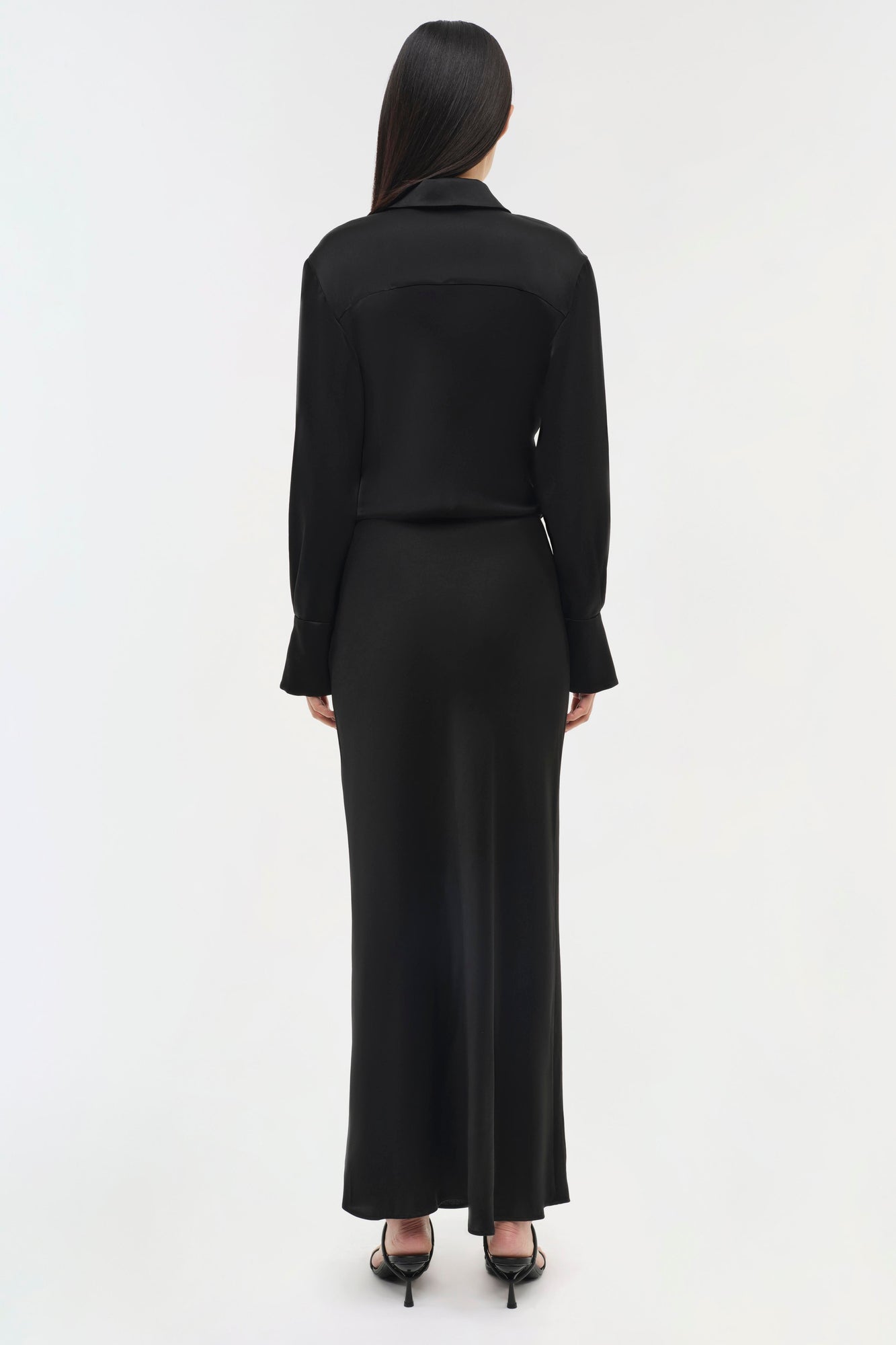 Black long-sleeve collared dress with a fitted bodice and flowing maxi skirt, shown from back view.