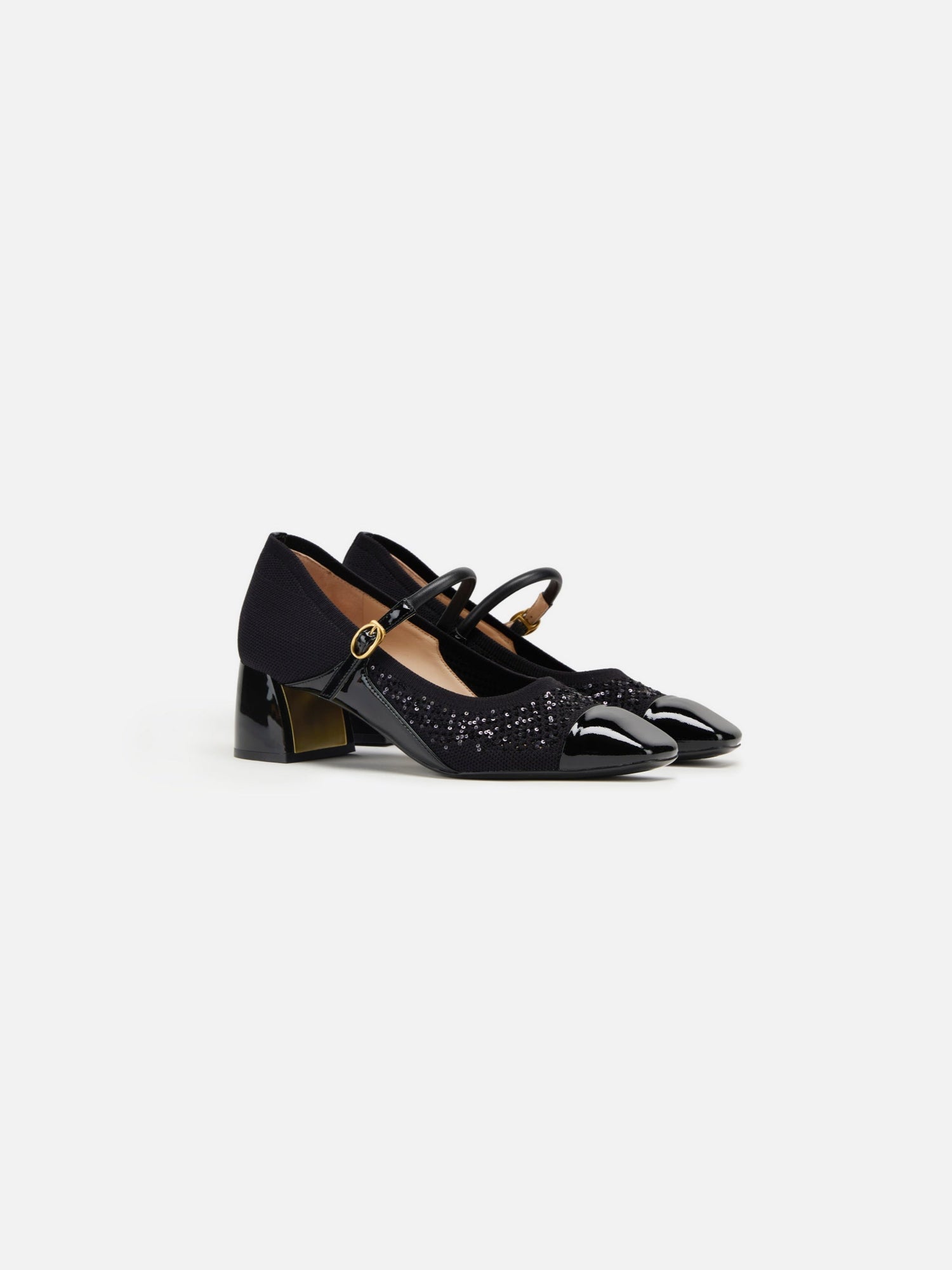 A pair of navy blue, square toe, high-heeled shoes with a buckle strap and a dotted pattern.
