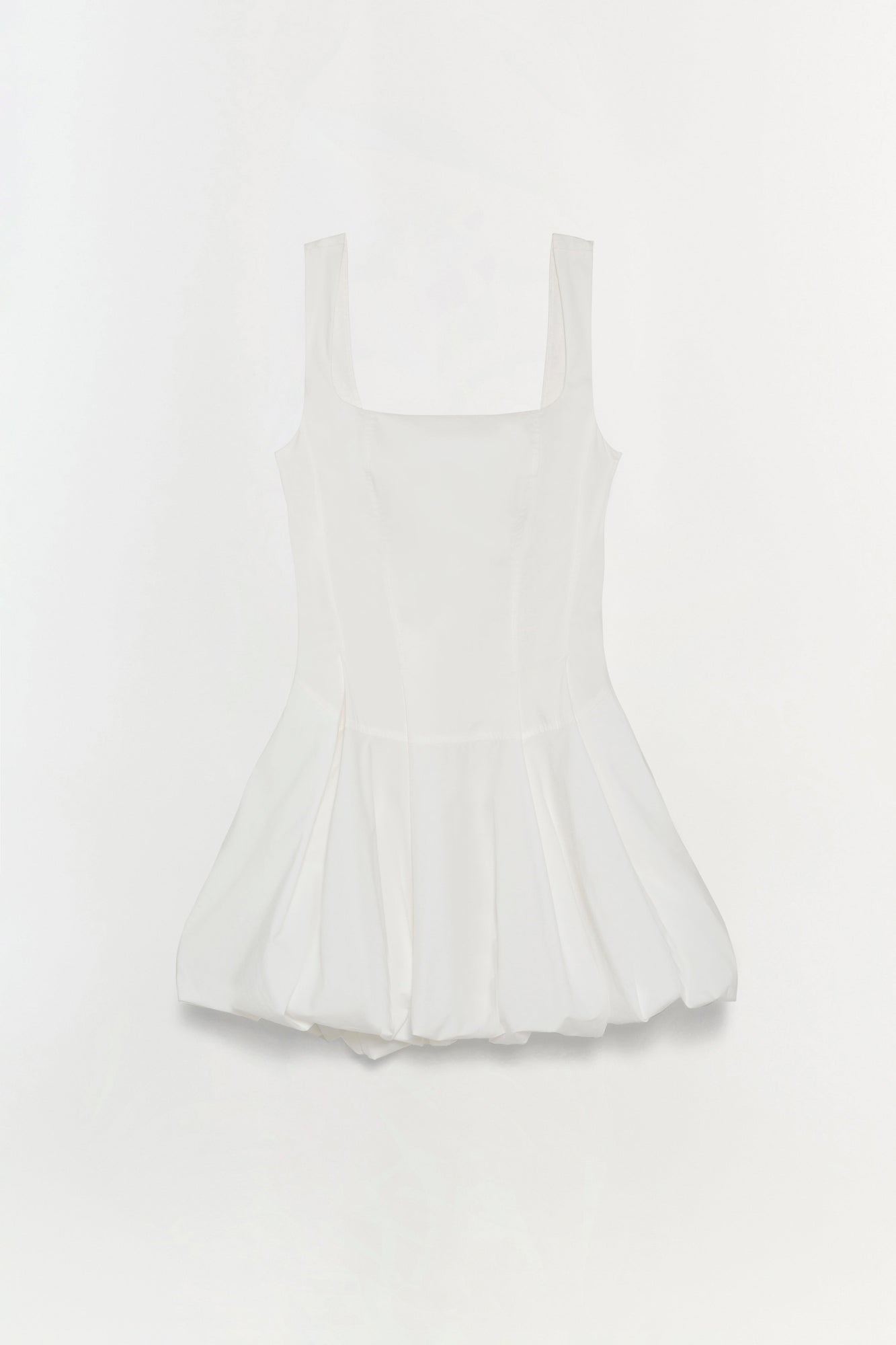White cotton poplin mini dress with square neckline, sleeveless design, and pleated skirt.