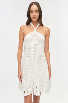 White halter mini dress with eyelet cutout knit pattern throughout.