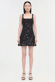 Black sleeveless dress with silver sequin embellishments and a square neckline, displayed on a model wearing black sandals.