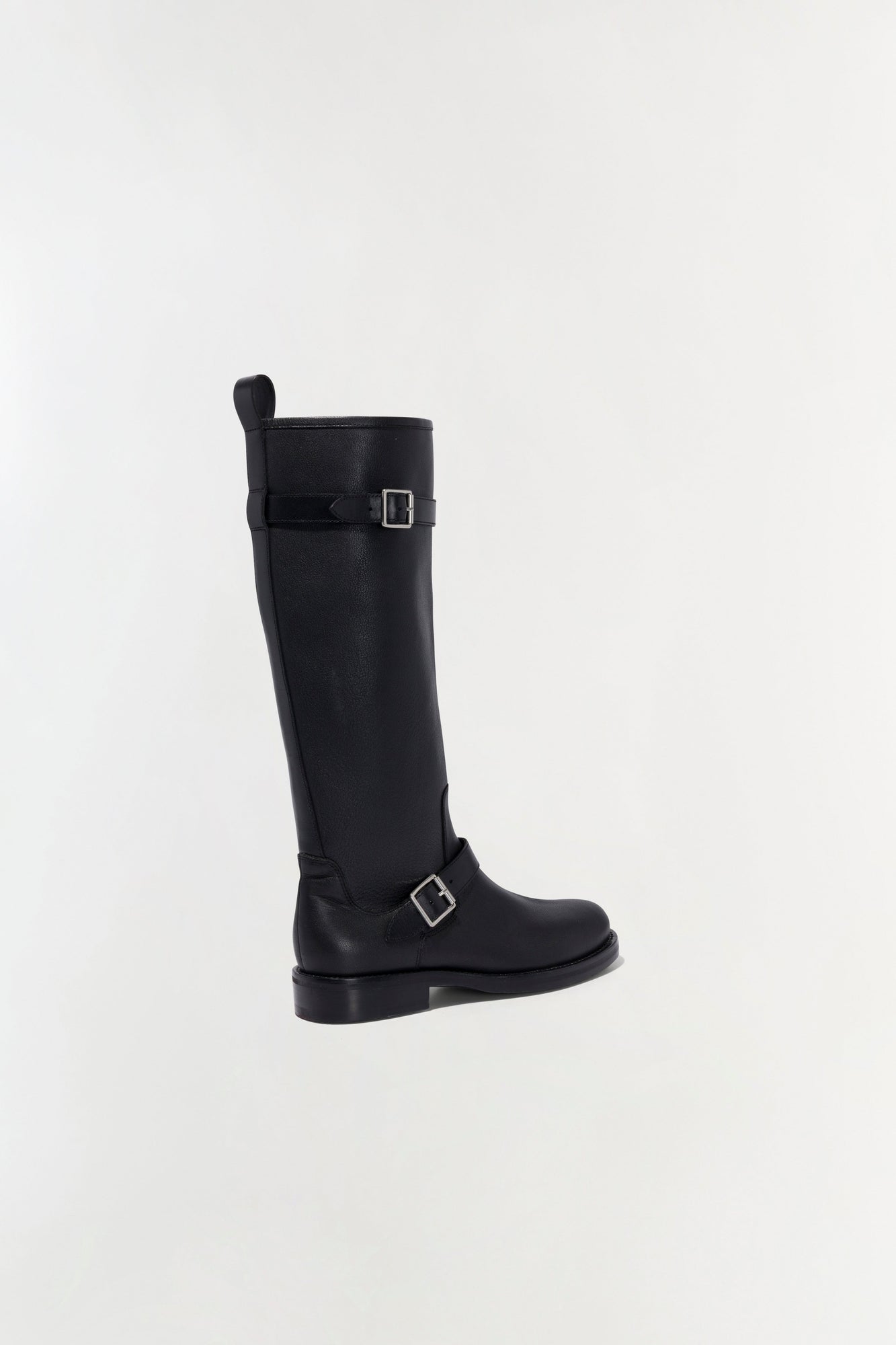 Black leather tall boot with buckle straps and flat sole, shown in profile view.