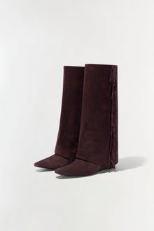 Burgundy suede boots with fringe trim down the back of the calf.