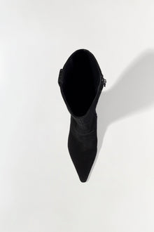 Black suede knee-high boot with pointed toe and side buckle detail, shown from above.