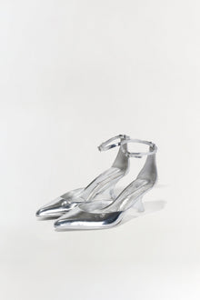 Silver metallic leather wedge heels with pointed toe and ankle strap closure.