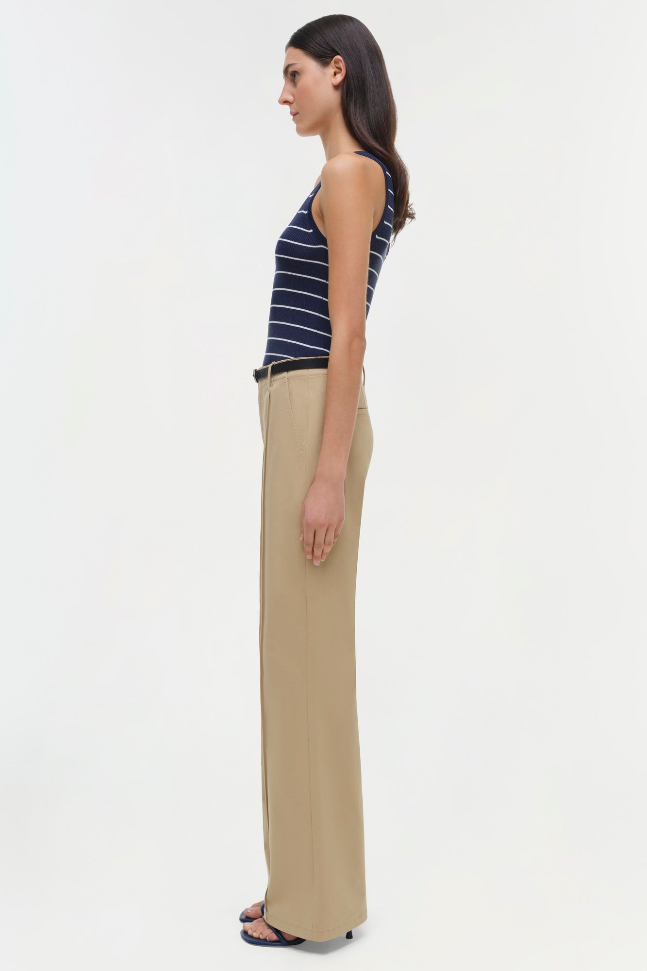 Beige wide-leg trouser with high waist, shown from side on model wearing navy striped tank top.