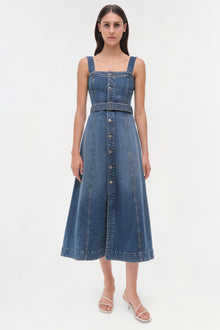 Blue denim sleeveless dress with square neckline, button front, and belted waist on model.