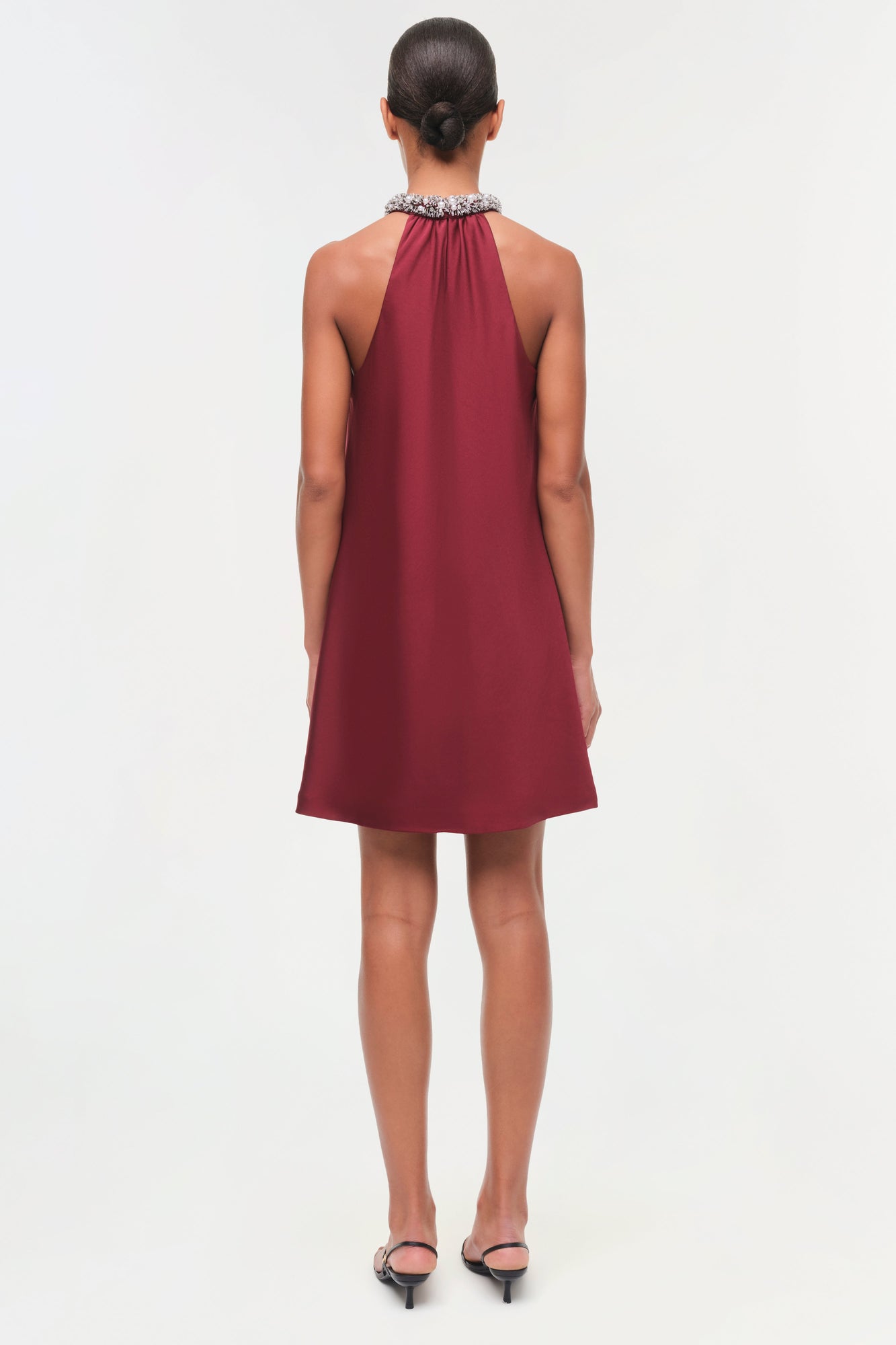 Burgundy halter mini dress with jeweled neckline, viewed from back.
