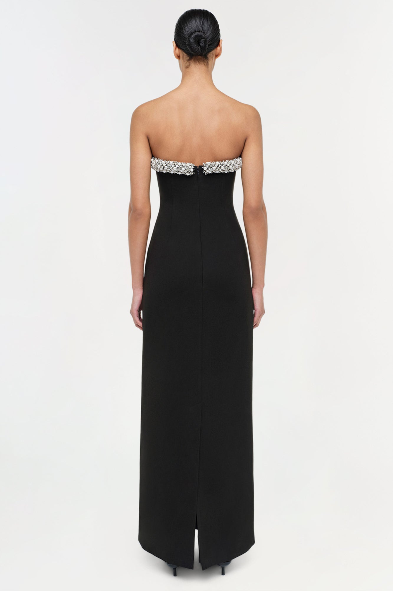 Black strapless floor-length gown with crystal embellished bustier trim and center back slit.