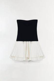 Black knit strapless top with cream taffeta skirt featuring layered ruffled hem.