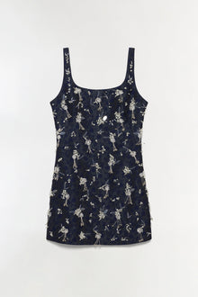 Navy sleeveless mini dress with white floral and botanical embellishments throughout, featuring a scoop neckline and fitted s