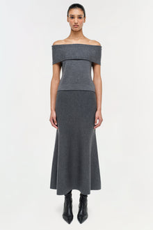 Charcoal gray wool off-shoulder top with short sleeves and fitted waist, shown on model with matching midi skirt.