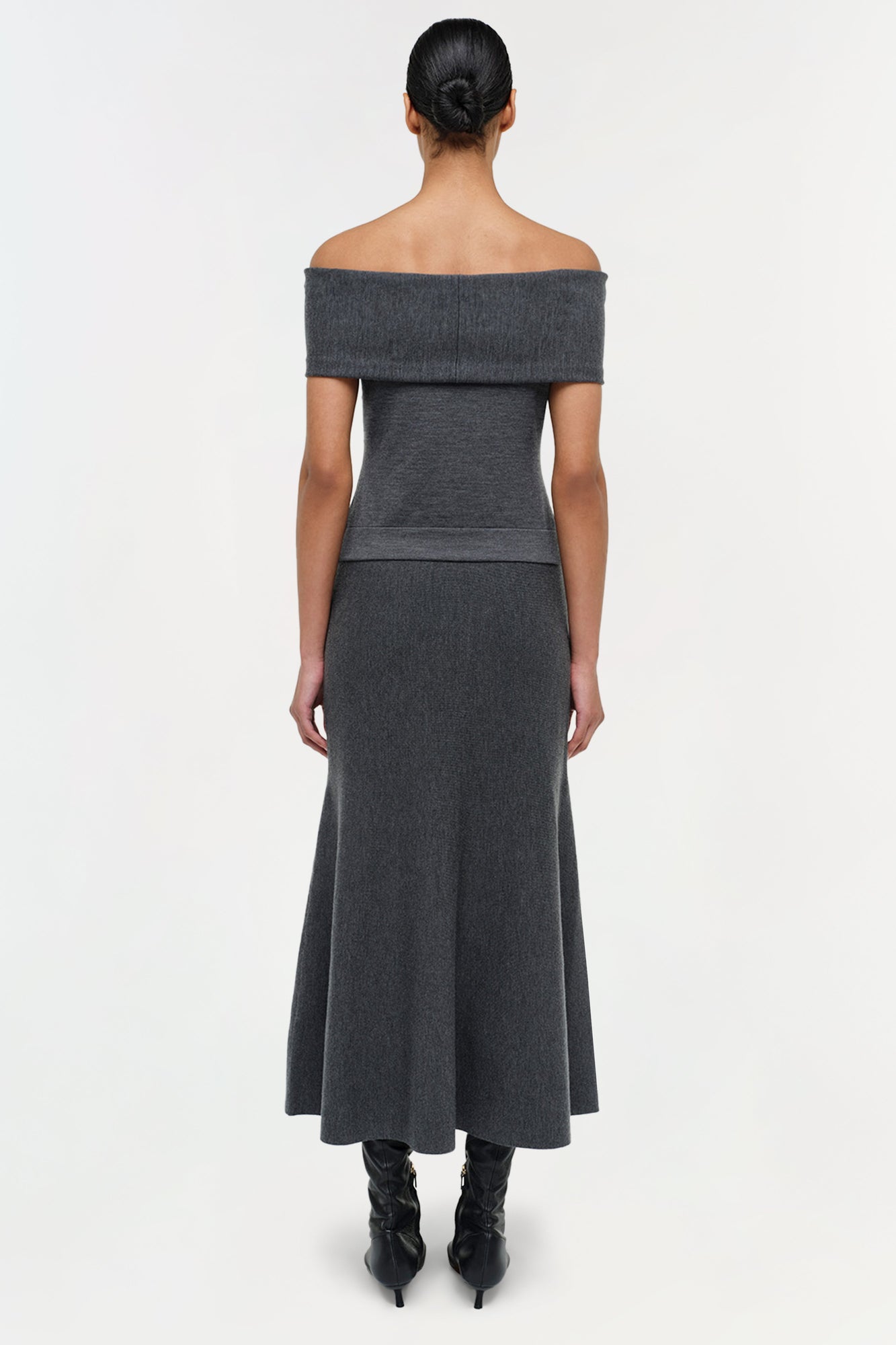 Charcoal wool skirt with A-line silhouette, worn with matching off-shoulder top and black boots.