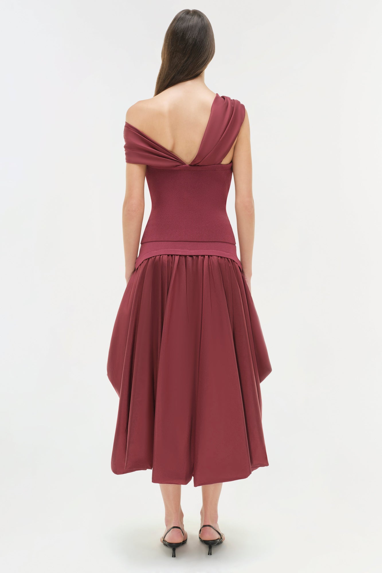 Burgundy off-shoulder top with draped neckline and fitted bodice, shown from back view on model.