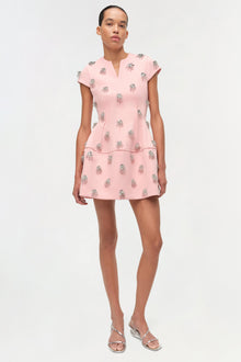 Pink mini dress with silver beaded embellishments, short sleeves, and a tiered skirt design.