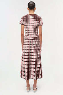 Burgundy and pink knit midi skirt with scalloped edge details and geometric pattern, shown from back view.