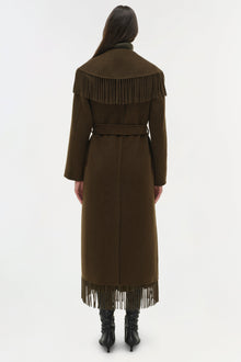 Olive green wool coat with fringe trim on shoulders and hem, belted waist, and long sleeves, shown from back.