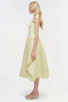 Pale yellow strapless midi dress with fitted bodice and full skirt, shown on model in profile view.