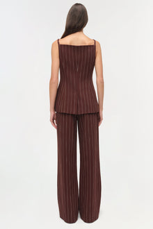 Woman wearing burgundy pinstriped sleeveless top with matching wide-leg pinstriped pants, shown from back view.