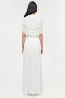 White draped jersey cape maxi dress with pleated skirt, shown from back view on model.