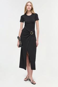 Black knit midi dress with short sleeves, side ruching detail with gold ring buckle, and asymmetrical hem slit.