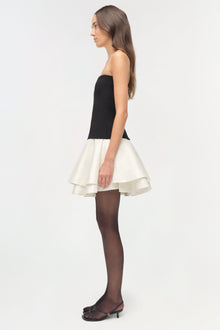 Strapless mini dress with black knit bodice and cream taffeta skirt, shown with dark tights and black heels.