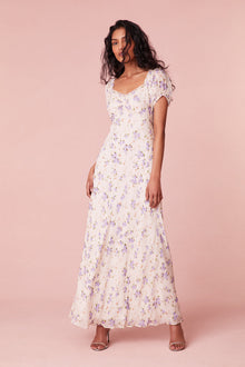 Floral printed maxi dress with short puff sleeves, a slightly square neckline with ruching at center front, and a breezy maxi skirt.