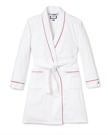 The Mens Flannel Robe by Petite Plume exudes luxury with its shawl collar, red piping accents, self-tie waist belt, and two front pockets. Crafted from flannel fabric for comfort and style, it is showcased against a plain white background.
