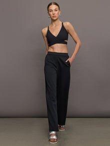 Model wears black wide leg pants with an elastic waistband. 