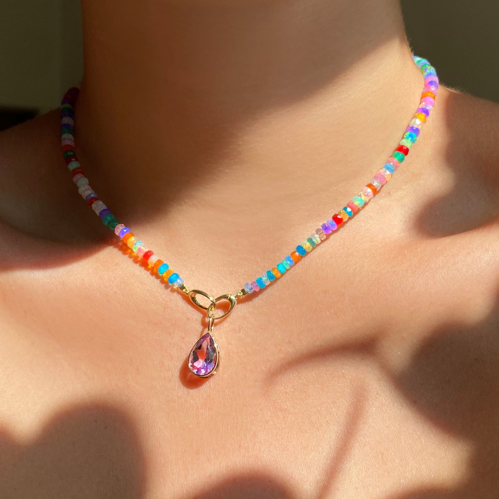 Tie dye opal necklace with an amethyst charm on the neck.