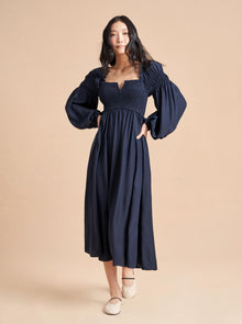 Named after La Bande member, Bettina Prentice, this romantic, airy, Pre-Raphaelite inspired dress in navy silk charmeuse is heaven-sent. Float away in its long balloon sleeves, smocked bodice for ease and the feminine open neckline.