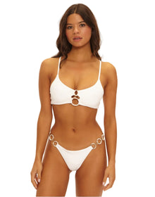 Woman wearing a white bikini with a plain background