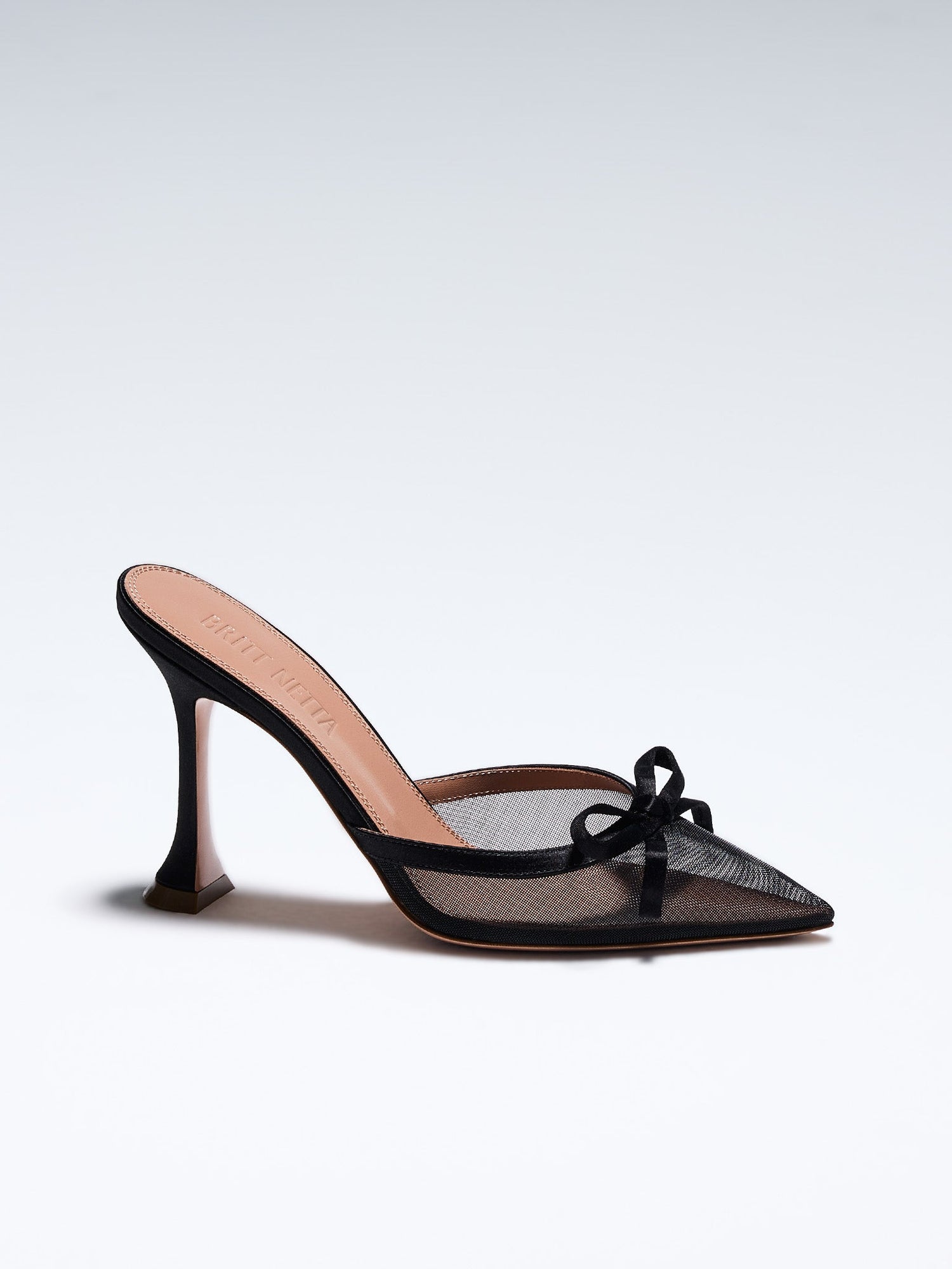 Hand-crafted in Italy, the Amelia ("Amelia") mule features a glossy black satin and is set upon our custom 95mm heel designed for your comfort. Amelia is accented with our signature mesh upper that gently molds to your foot and features an elegant satin bow making it the perfect addition to your wardrobe this holiday season.