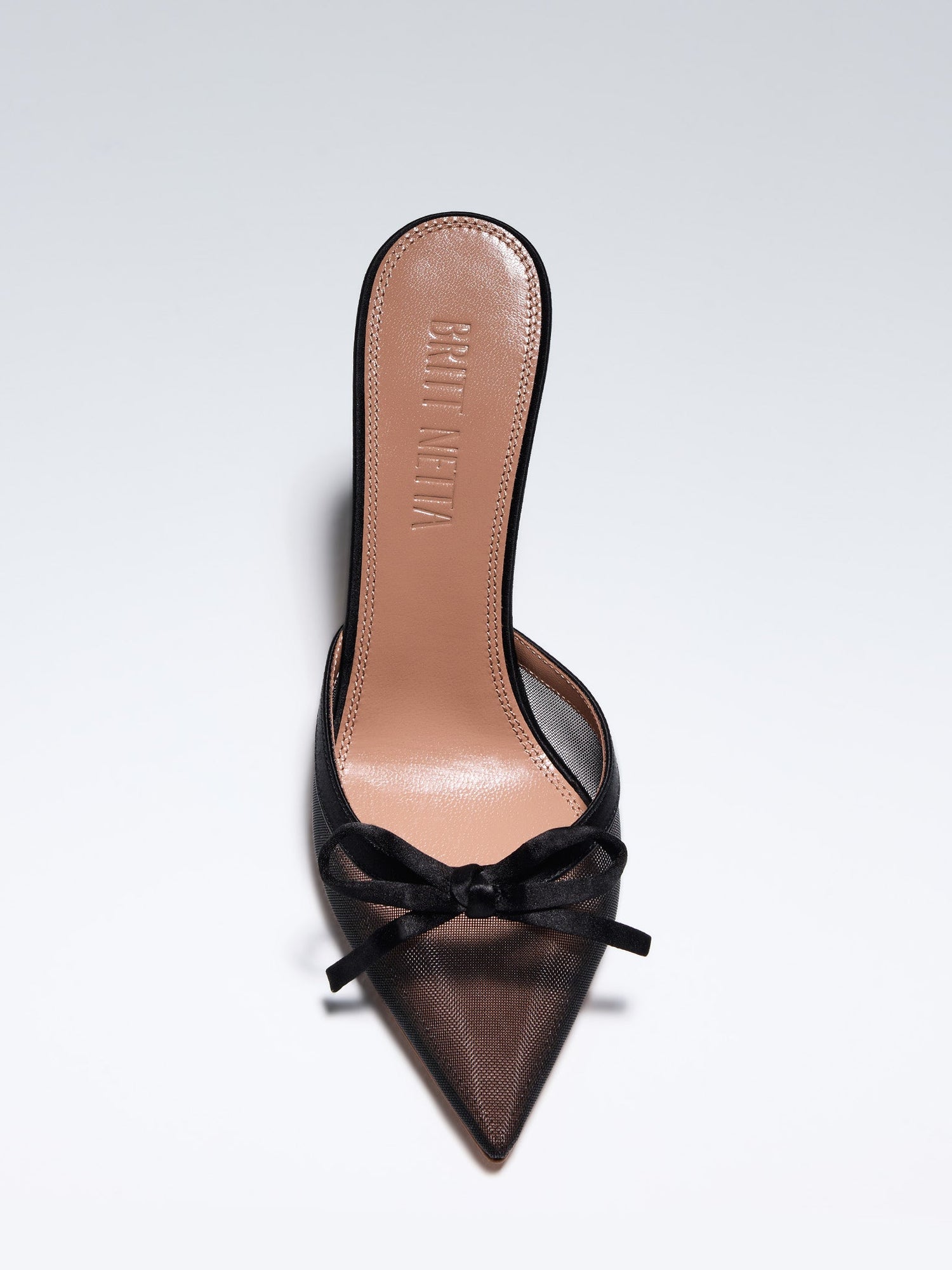 Hand-crafted in Italy, the Amelia ("Amelia") mule features a glossy black satin and is set upon our custom 95mm heel designed for your comfort. Amelia is accented with our signature mesh upper that gently molds to your foot and features an elegant satin bow making it the perfect addition to your wardrobe this holiday season.