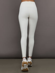 Model wears a highly compressive white high waisted legging. 