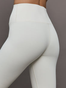 Model wears a highly compressive white high waisted legging. 