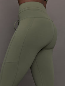 Close-up of waistband and pocket detail on Melt High Rise Sport Pocket Legging Moss.