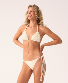 Woman wearing a beige bikini set on a white background
