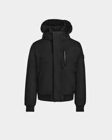The Rudsak DEACON - M123513 Black/Black mens bomber down puffer coat features a front zipper, snap closures, chest zip pocket, ribbed cuffs and hem, and a fur-lined hood with RDS-certified down, shown on a light gray background.