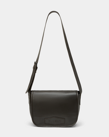 The Rudsak GRAYSON - 8324512 Espresso is a dark brown leather crossbody bag featuring a flap closure, adjustable shoulder strap, minimalist rectangular design, and a subtle embossed logo on the front flap.